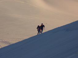 young couple walking uphill in desert