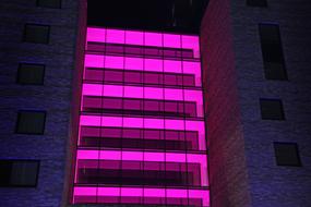 Pink illumination on facade of building at Night