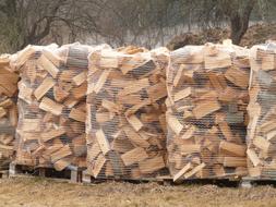 chopped firewood in nets on the field
