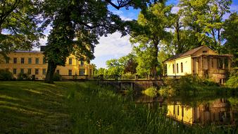 Beautiful castle, among the beautiful and colorful plants, with the water, in SteinhÃ¶fel, Brandenburg, Germany