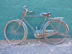 Beautiful, old, blue bike, near the turquoise wall