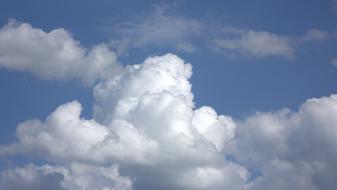 white fluffy clouds in the sky on a sunny day