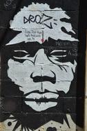 Black and white graffiti of the face on the wall