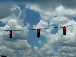 Three Red traffic Lights on line at sky
