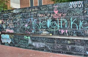 Colorful and beautiful chalkboard graffiti on the fence, near the buildings