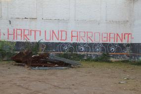 graffiti with red lettering on an abandoned building