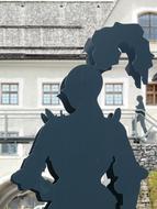metal figure of a knight on the background of the house