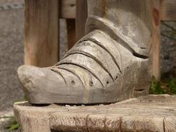 foot in wooden shoes as a sculpture