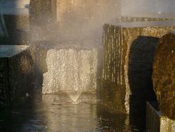 big stones in a fountain in the bright sun