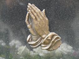 Praying hands, sculpture on Tombstone