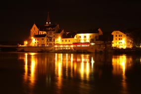 Beautiful houses, with the lights, on the shore, in Seysell, France, at the night