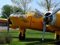 Yellow Two Engine Propeller Plane