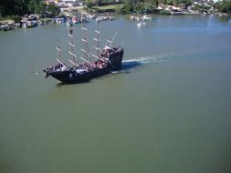 aerial view of a sailboat in the harbor on a sunny day