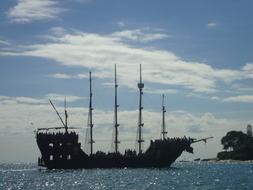 crowd of people on sailing ship near coast