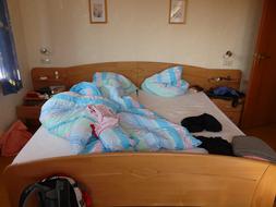 Colorful, wooden bed in the room of the hotel