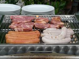 raw Meat and Sausage on Grill