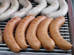 Colorful sausages, for the barbecue grilling, on the grill