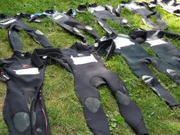 diving suits on green grass