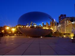 Beautiful landscape with the bean among the buildings with colorful lights in Chicago