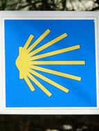 Blue and yellow symbol of the Camino De Santiago in Jakobsweg