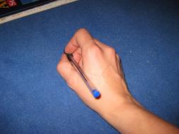 pen in hand on blue background