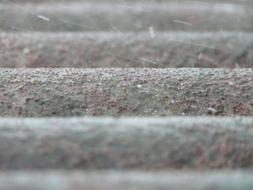 Raindrops falling on roof close up