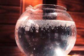 Water with the bubbles, in the shiny, glass container, in light