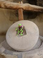 toy frog on aged Grindstone