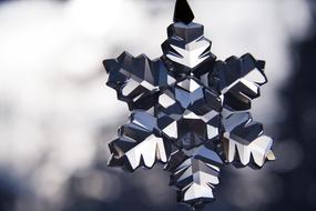 crystal snowflake on blurred background