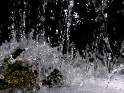 Beautiful, shiny water splash, at black background