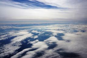 Aircraft view of the beautiful blue sky with clouds, above the landscape