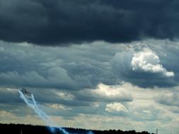 Flying "Lockheed Martin F 16" fighter jet in the cloudy sky, in Farnborough, England, UK