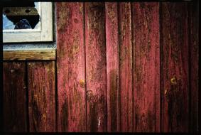 window on red wooden wall