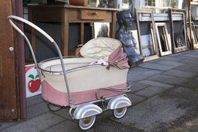 Colorful baby carriage and other stuff on the flea market