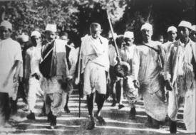 Mohandas Karamchand Gandhi walking among men, historical photo
