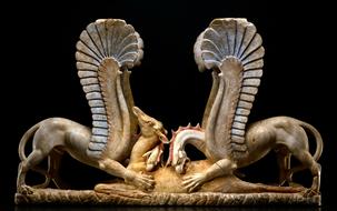 Beautiful marble statue of Trapezophoros, from the Ancient Greek, in the museum, at black background