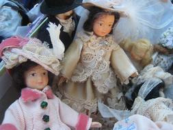 Close-up of the colorful, vintage dolls in the clothing, on the antique market