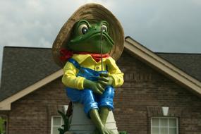 ceramic figure in the form of a frog wearing a hat
