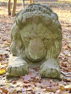 Lion Stone Sculpture red leaves