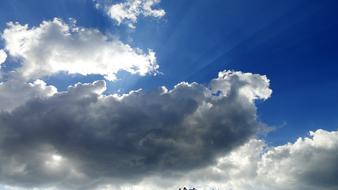 gray clouds in blue sunny sky