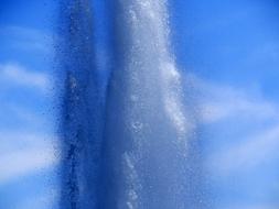 fountain splash on blue sky background