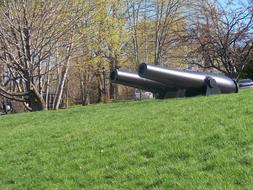 cannons on a green hill on a sunny day