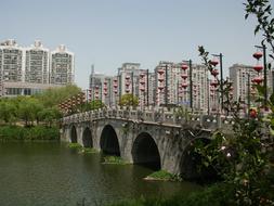 old stone Bridge in front of contemporary city, china, nanjing