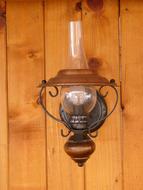 vintage gas lamp on wooden wall