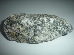 Close-up of the colorful granite stone in light, on the white surface