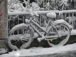 bike in the snow near the fence