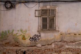 Colorful wall of the old building, with window, in Romania