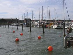 Colorful boats in the port, under the blue sky with white clouds