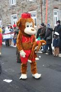 a man in a monkey costume at the parade