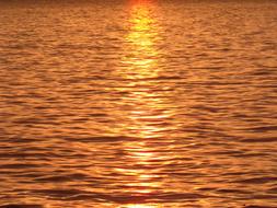 sun mirroring on golden Water, background